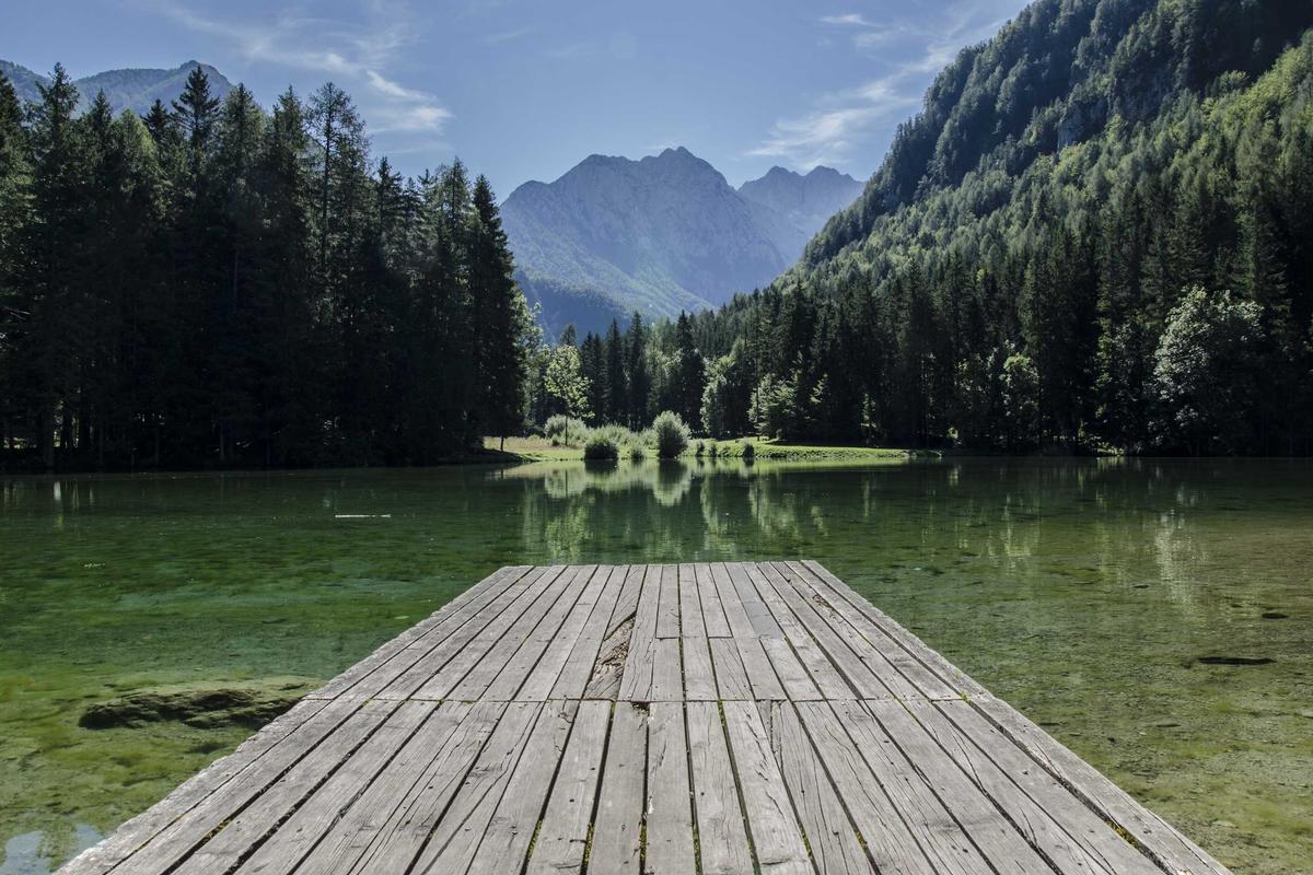 Turquoise waters of Heavenly Lake reflecting snow-capped peaks