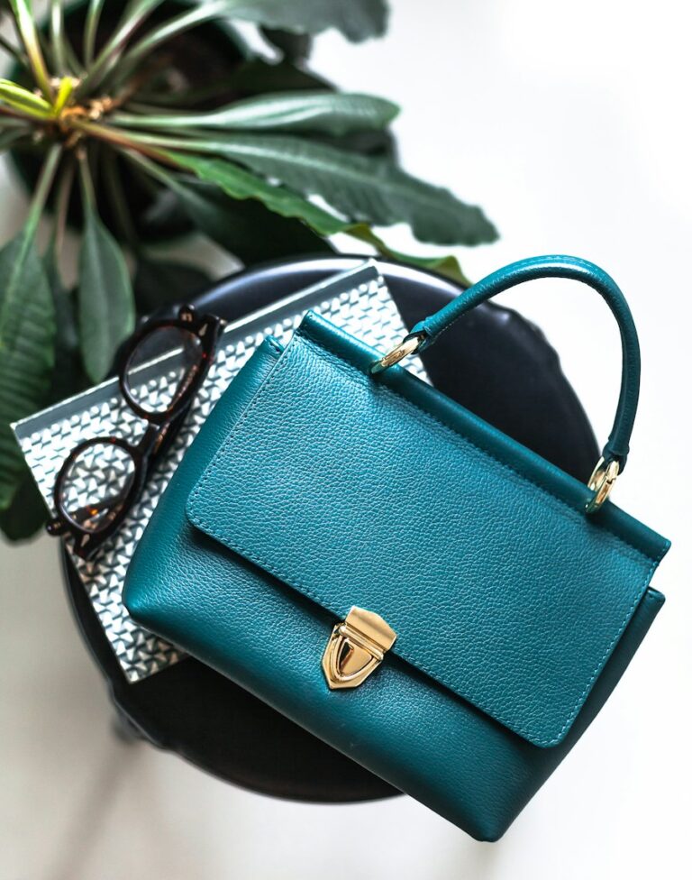 Pebbled leather handbag with a brass clasp and top handle