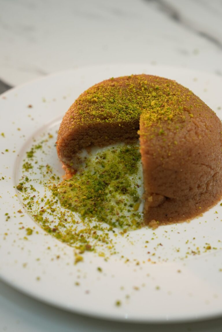 Semolina halva dome topped with crushed pistachios, a classic Silk Road sweet